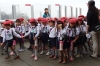 School children line up for their next adventure at Umitamgo (aquarium), Oita, Japan.  Note the shoes.