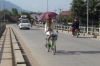 Young girl on bike with umbrella - how elegant!, Luang Prabang LA