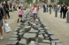 Eleanor skipping over rocks near Urbis, Manchester GB