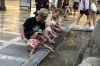 The girls having fun at the fountain in Plaza Nueva de Granada ES