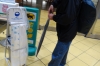 Bruce putting wet umbrellas into plastic bags, Beppu, Japan